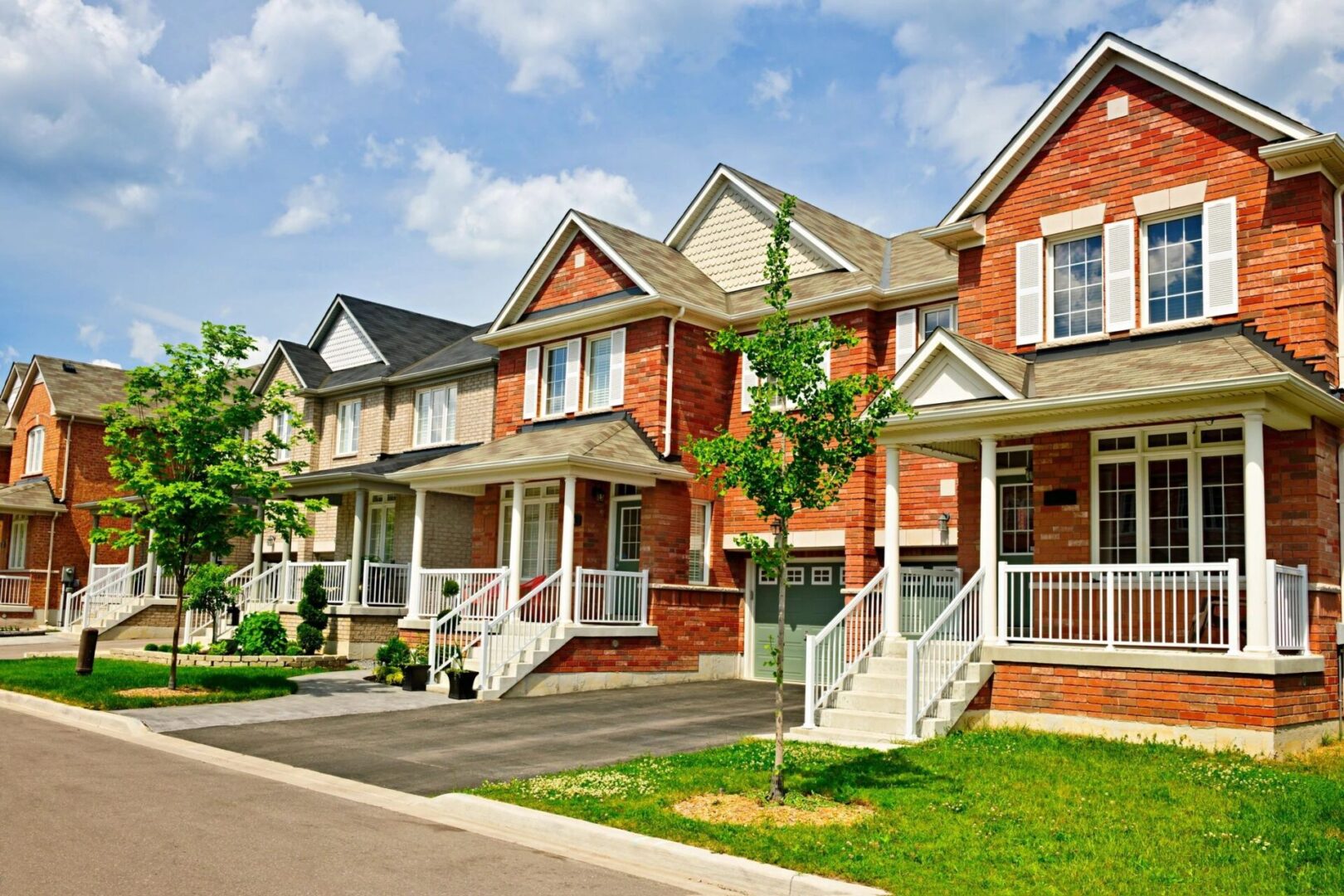 A row of houses with steps leading to the front.