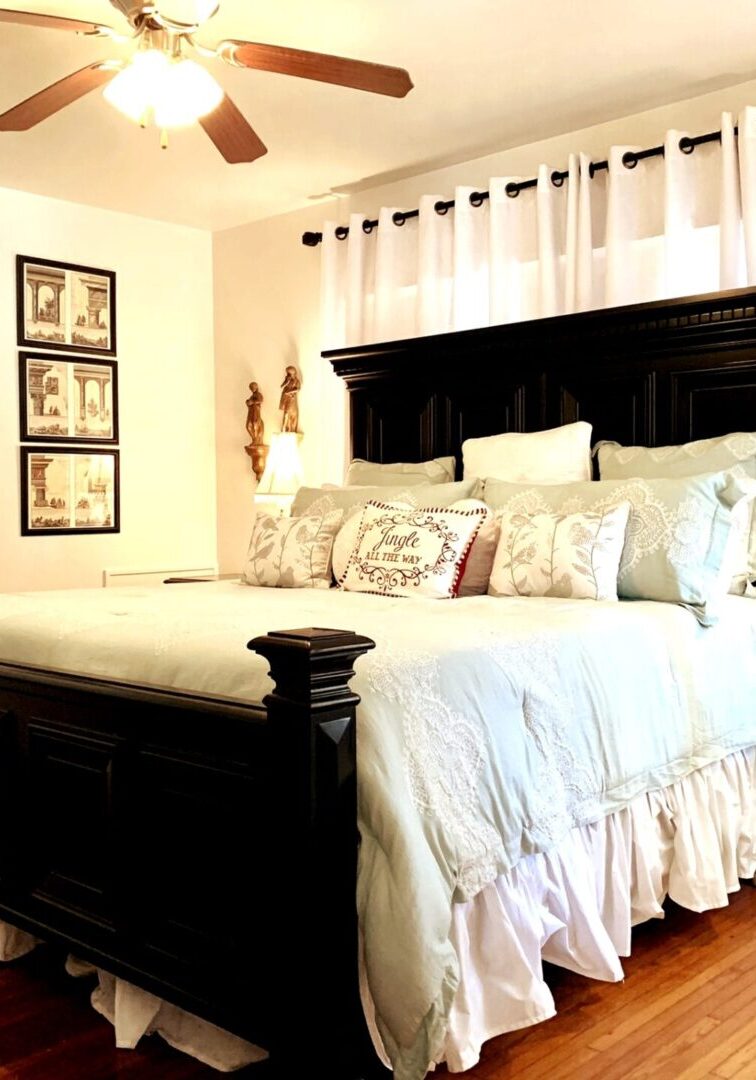 A bedroom with a bed, dresser and mirror.